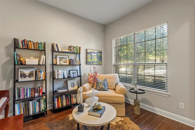 a living room with furniture and a book shelf