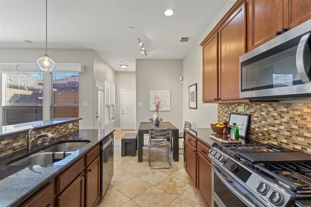 a kitchen with counter top space cabinets and stainless steel appliances