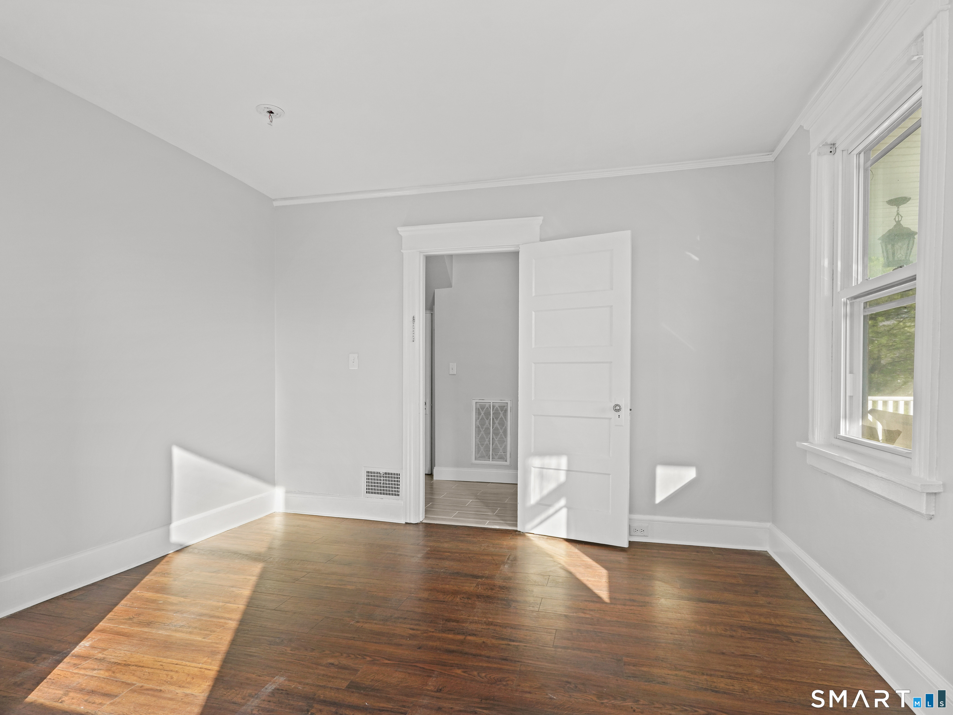 20 Cerretta Street Stamford, CT 06907 - Photo 12 of 22 a view of an empty room with wooden floor and windows