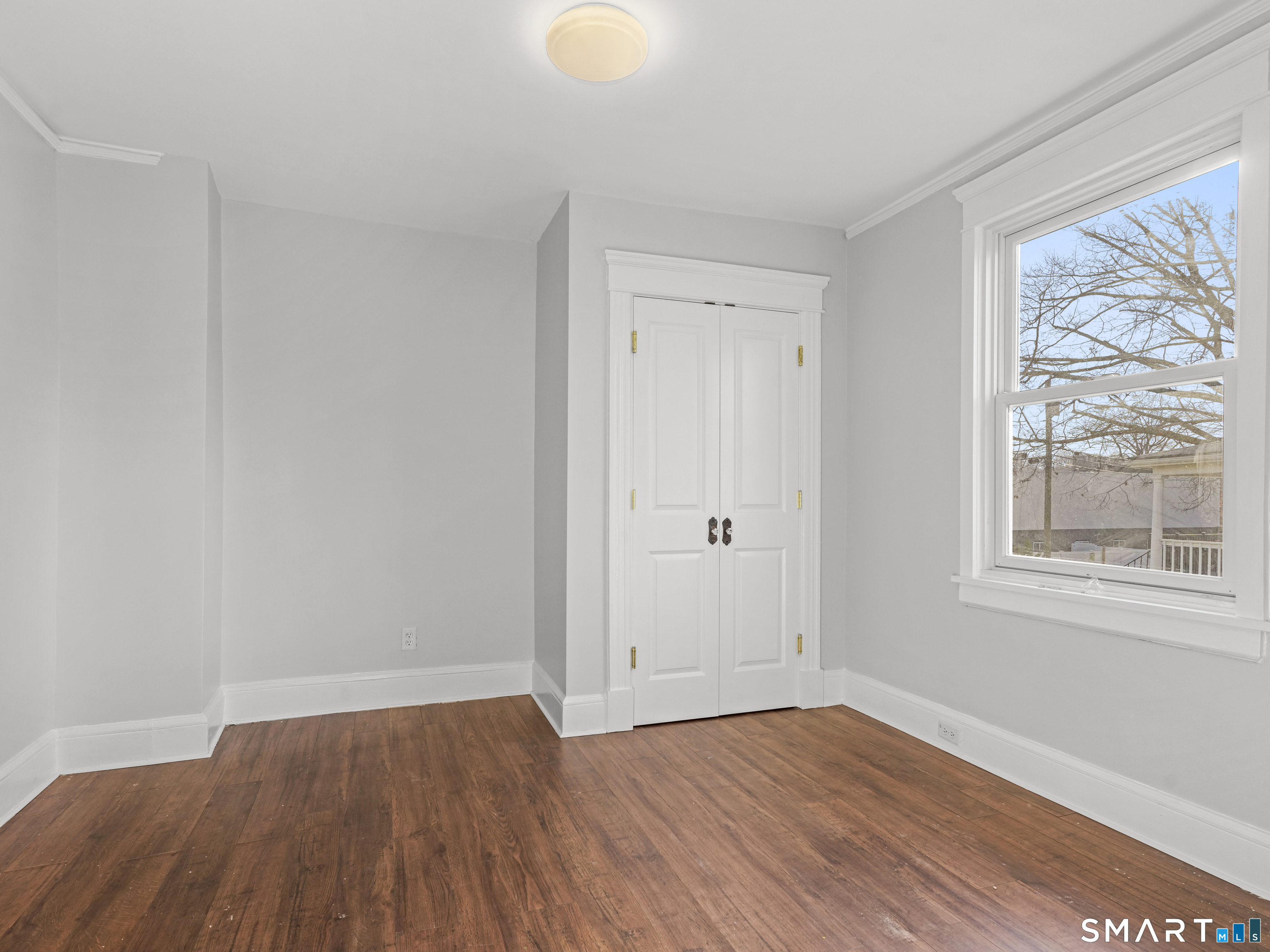 20 Cerretta Street Stamford, CT 06907 - Photo 15 of 22 a view of an empty room with wooden floor and a window