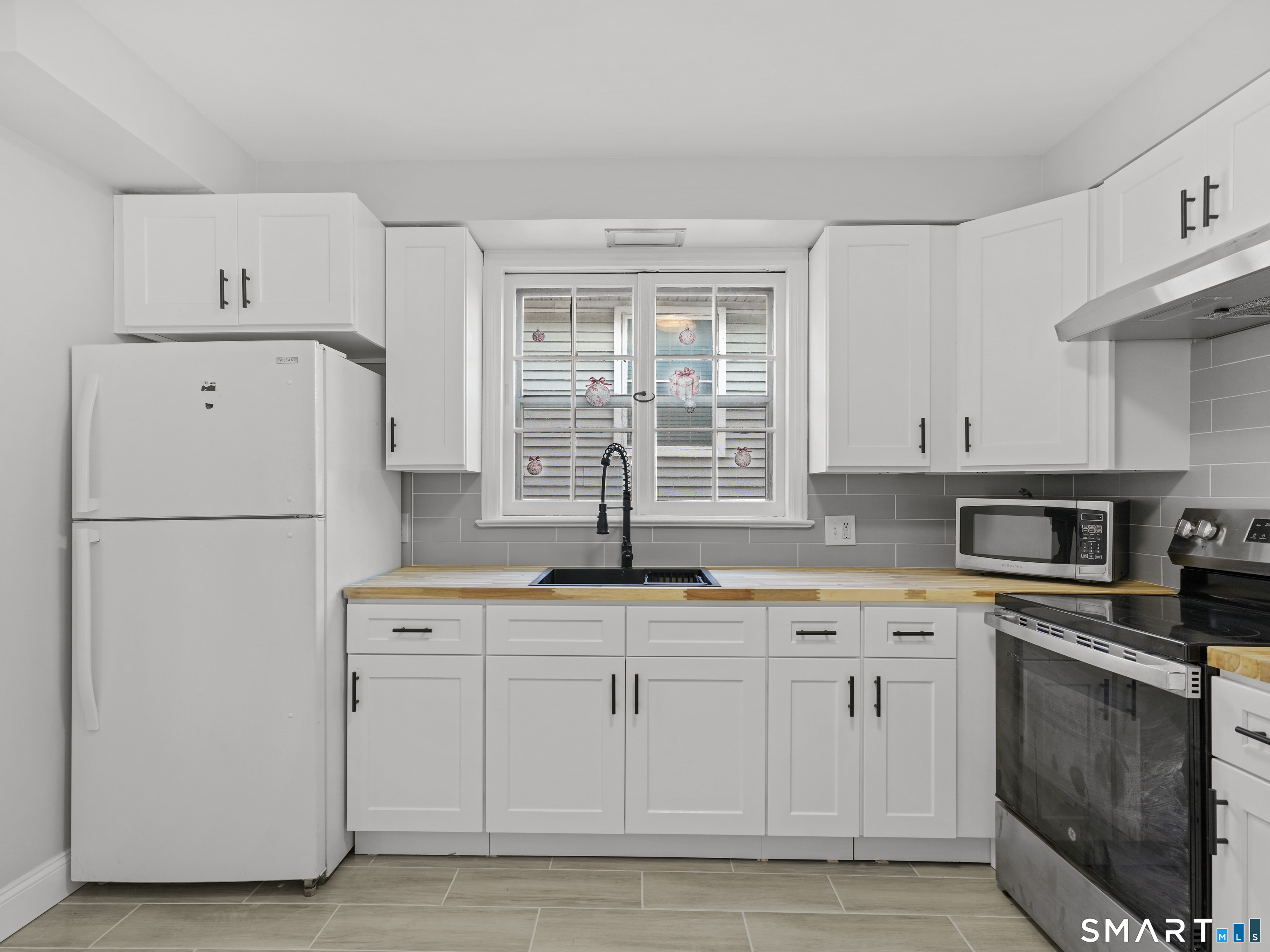 20 Cerretta Street Stamford, CT 06907 - Photo 8 of 22 a kitchen with white cabinets and white appliances