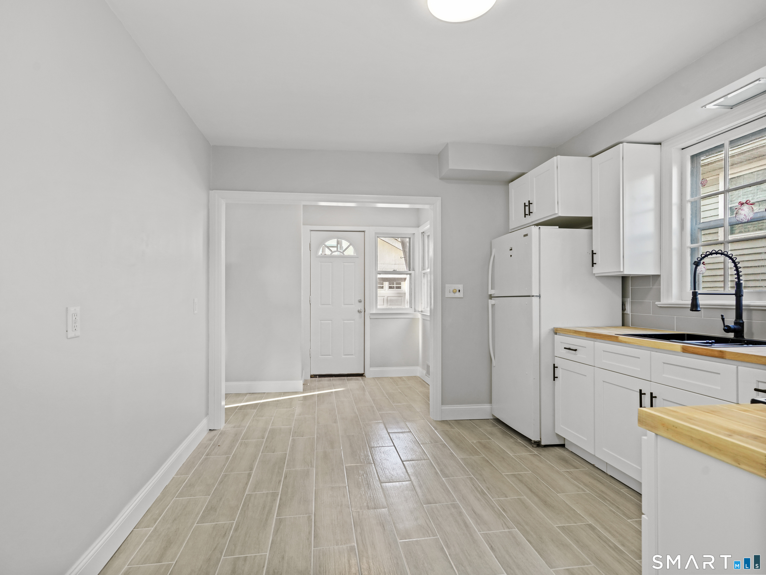 20 Cerretta Street Stamford, CT 06907 - Photo 9 of 22 a view of a kitchen with wooden floor and electronic appliances