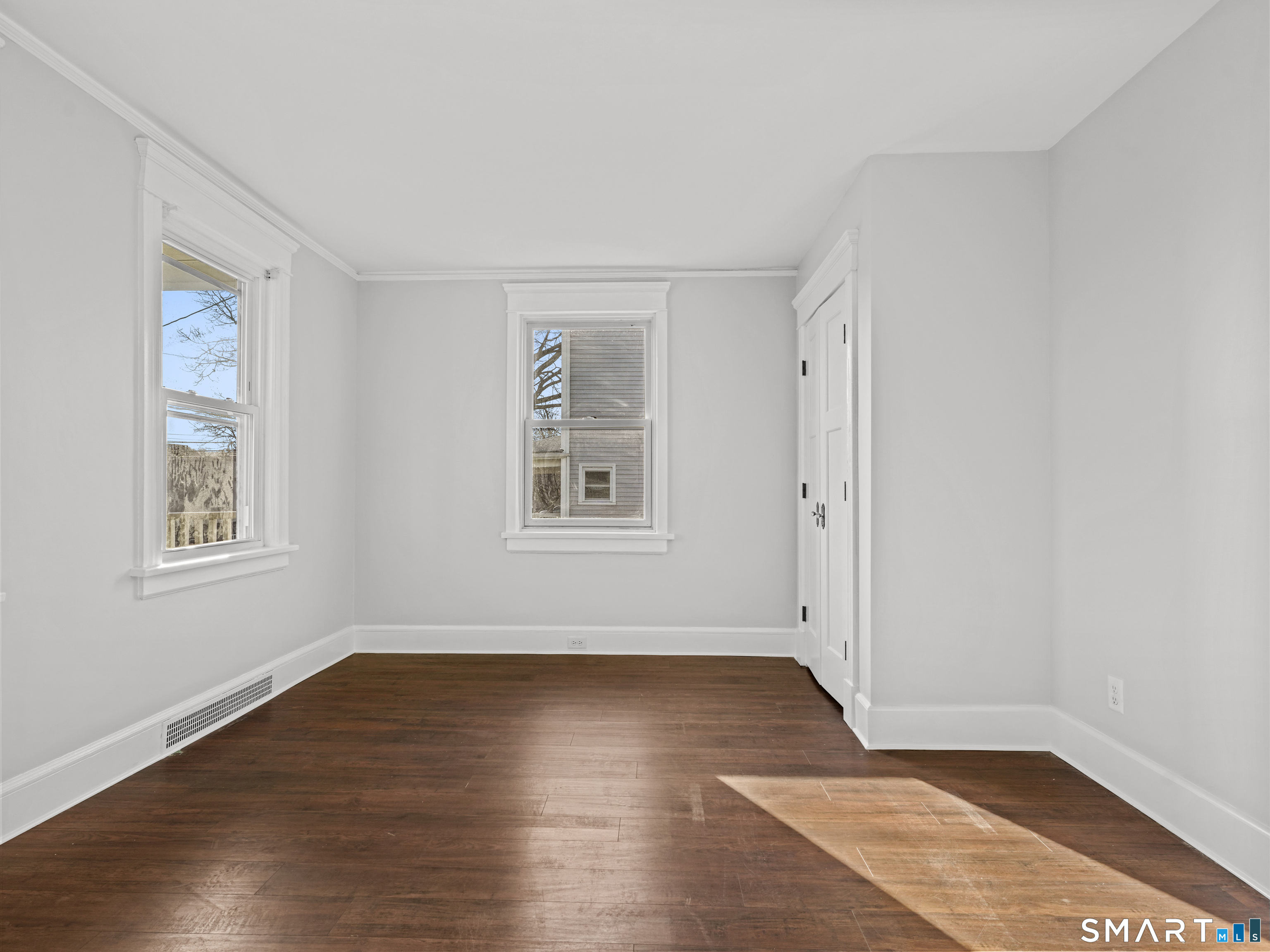 20 Cerretta Street Stamford, CT 06907 - Photo 10 of 22 an empty room with wooden floor and windows