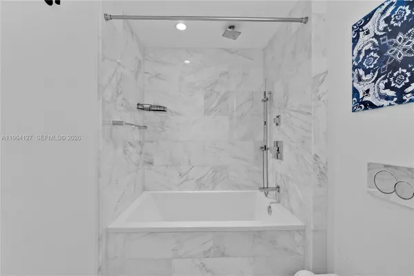 a bathroom with a shower and a bath tub