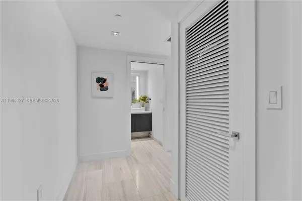 a view of a hallway with wooden shelves