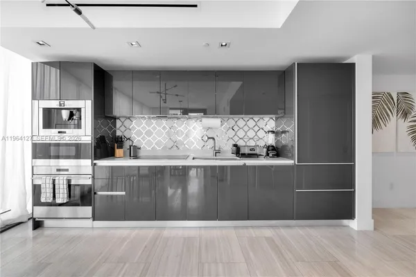 a view of kitchen with stainless steel appliances cabinets and wooden floor