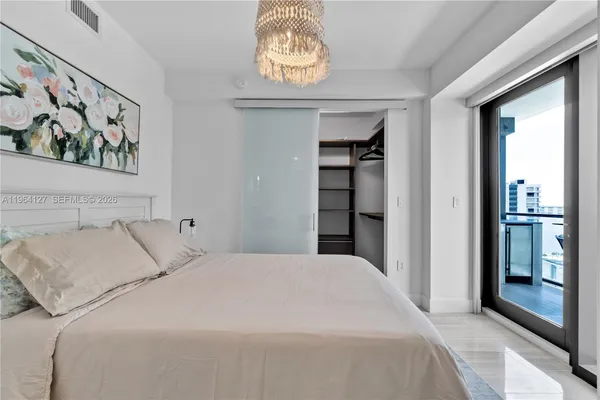 a bedroom with a bed and a window
