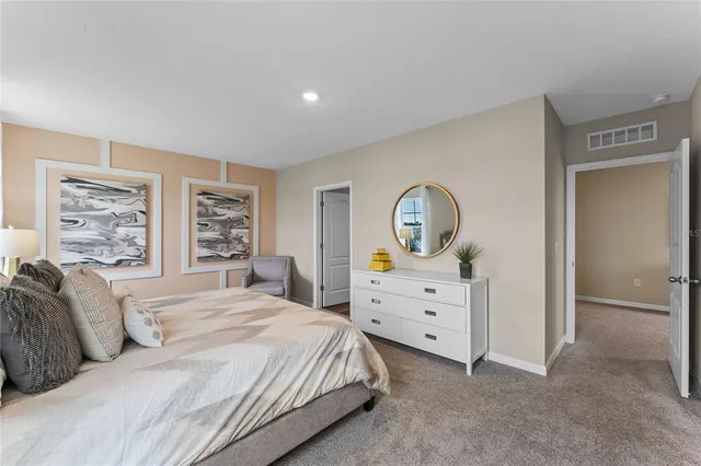 a bedroom with a bed and a dresser