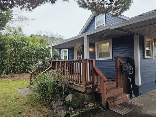 a view of backyard with deck and garden