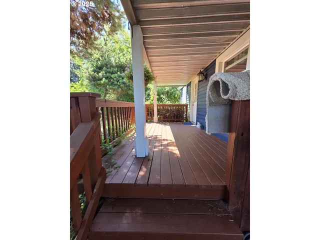 a view of deck with a table and chairs with wooden floor and fence