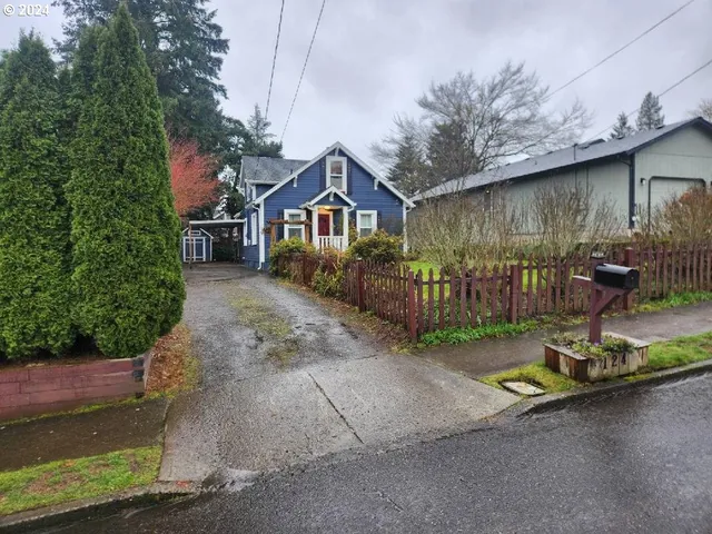 a view of a small house in front of a house