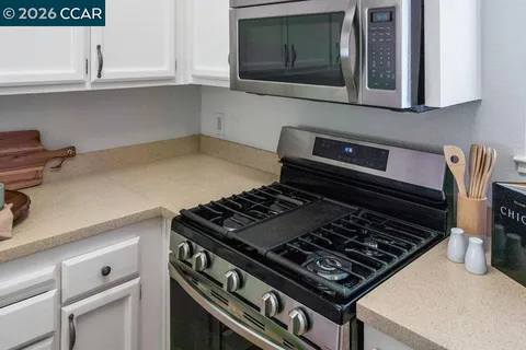 a stove top oven sitting inside of a kitchen