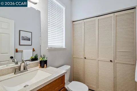 a bathroom with a sink a toilet and mirror