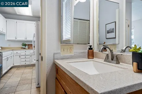 a kitchen with a sink a stove and cabinets