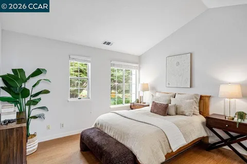 a bedroom with a bed and a potted plant