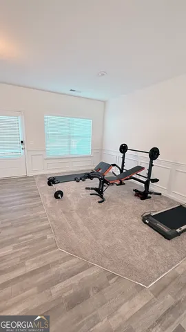 a living room with furniture pool and wooden floor