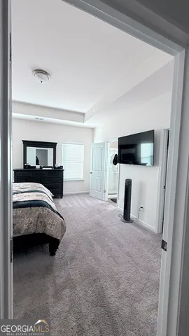 a view of a livingroom with furniture and a flat screen tv