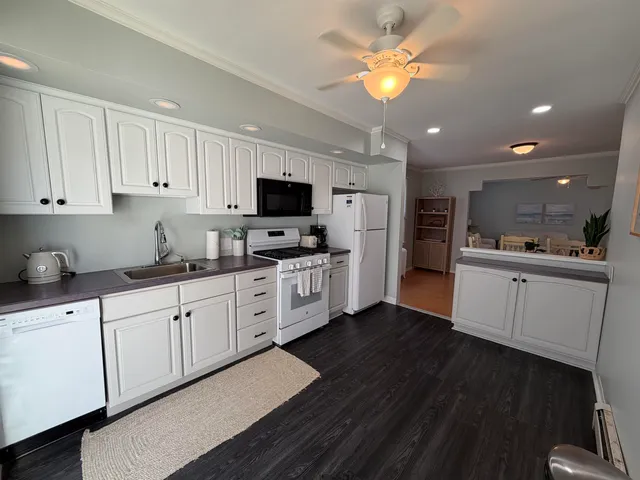 a kitchen with cabinets stainless steel appliances and a window