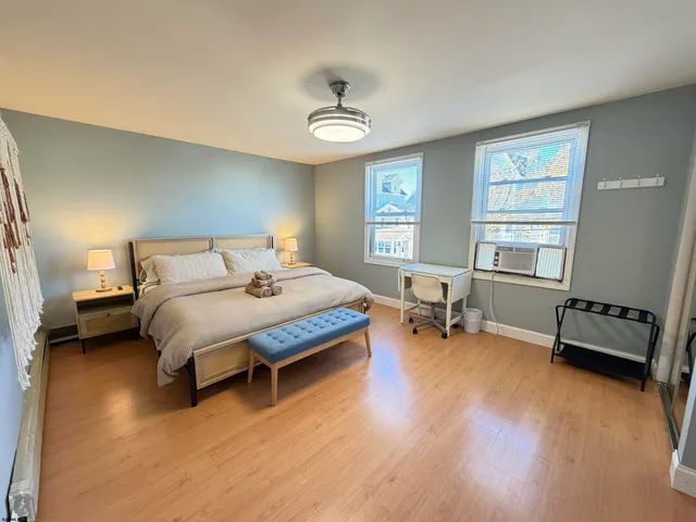 a bedroom with a bed and a window