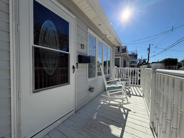 a view of a porch with wooden floor and windows