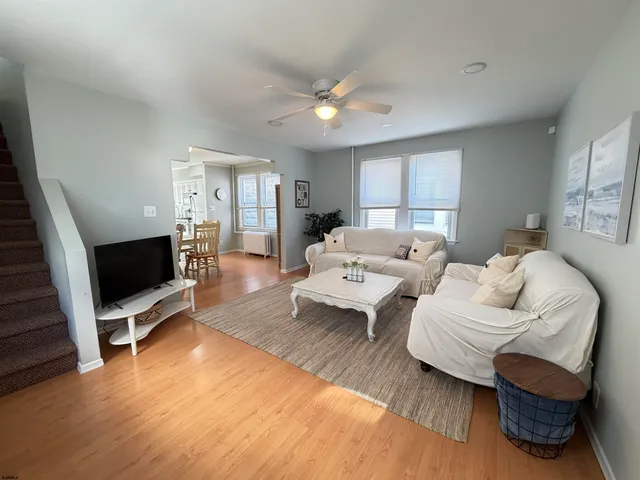 a living room with furniture flat screen tv and a fireplace
