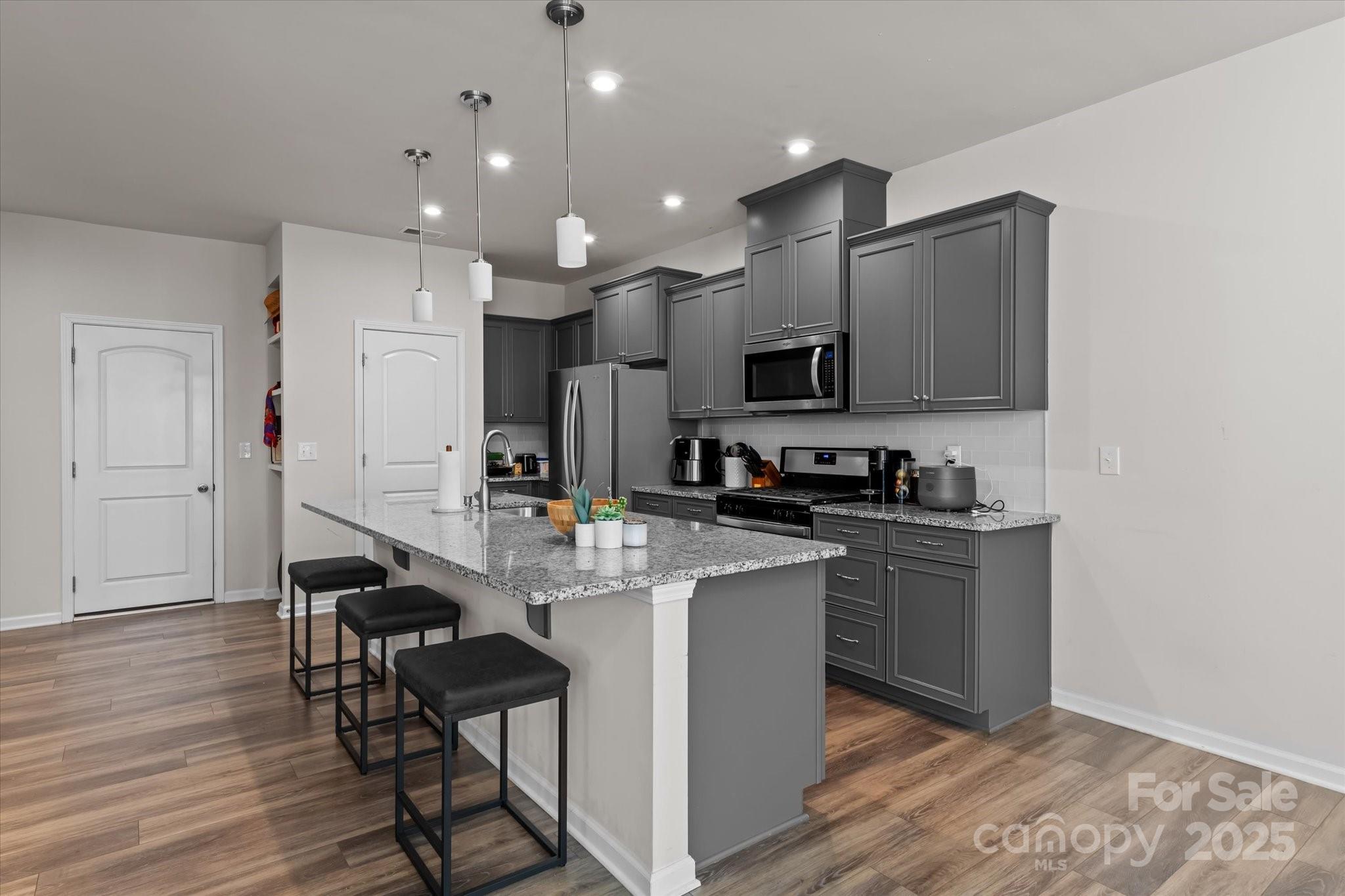 1564 Galloway Road Charlotte, NC 28262 - Photo 7 of 22 a kitchen with kitchen island stainless steel appliances a sink a stove a microwave and cabinets