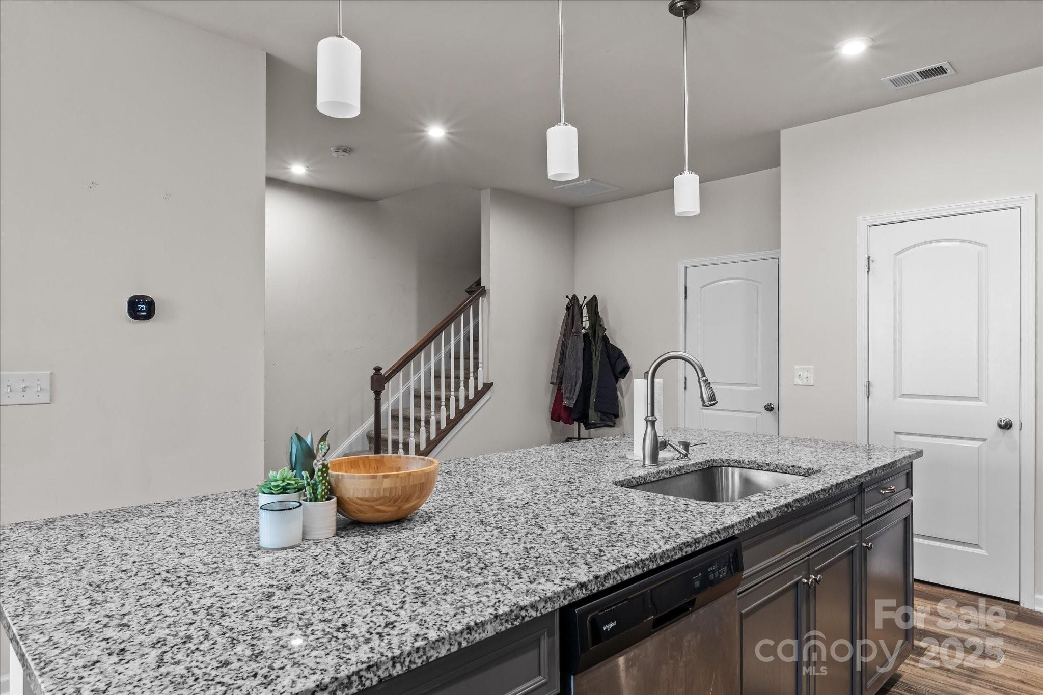 1564 Galloway Road Charlotte, NC 28262 - Photo 9 of 22 a kitchen with stainless steel appliances granite countertop a sink a counter space and a view of living room