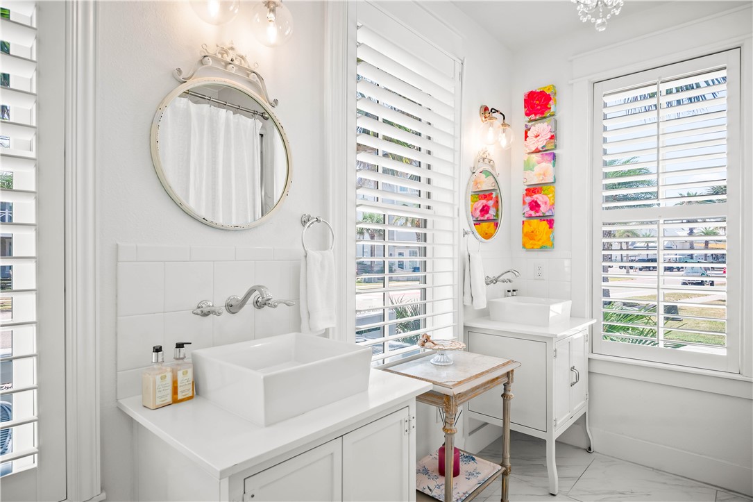 200 Round Road Port Aransas, TX 78373 - Photo 7 of 31 a bathroom with a sink a mirror and a window