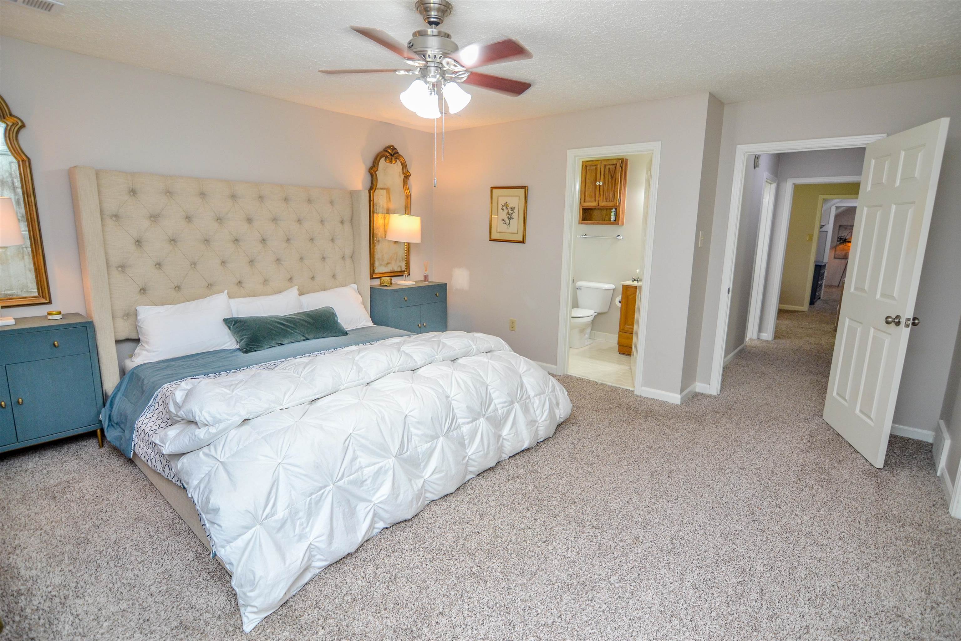 218 East Harpers Ferry Road Collierville, TN 38017 - Photo 13 of 25 a bedroom with a large bed and a chandelier