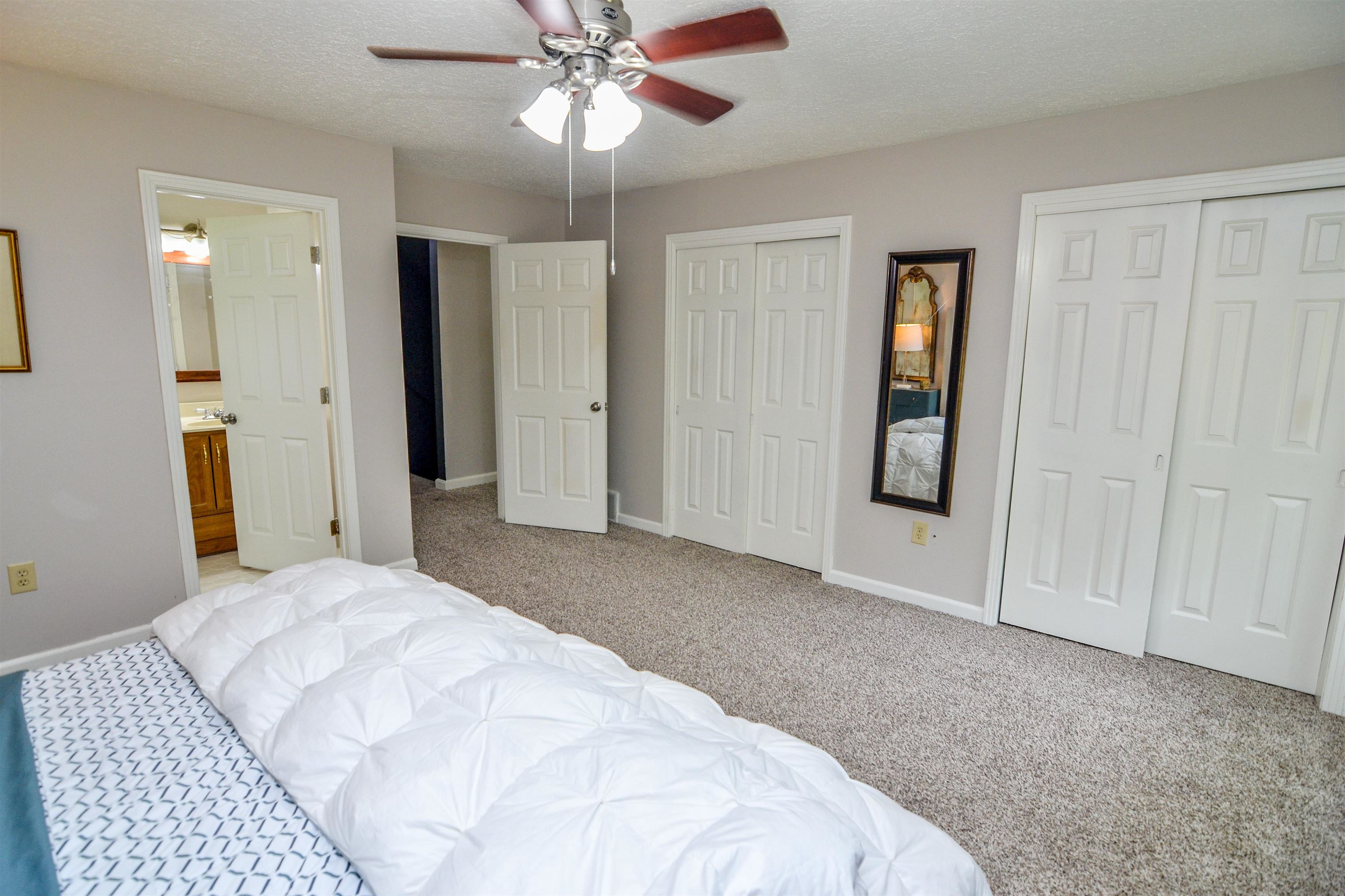 218 East Harpers Ferry Road Collierville, TN 38017 - Photo 14 of 25 a bedroom with a large bed and a chandelier