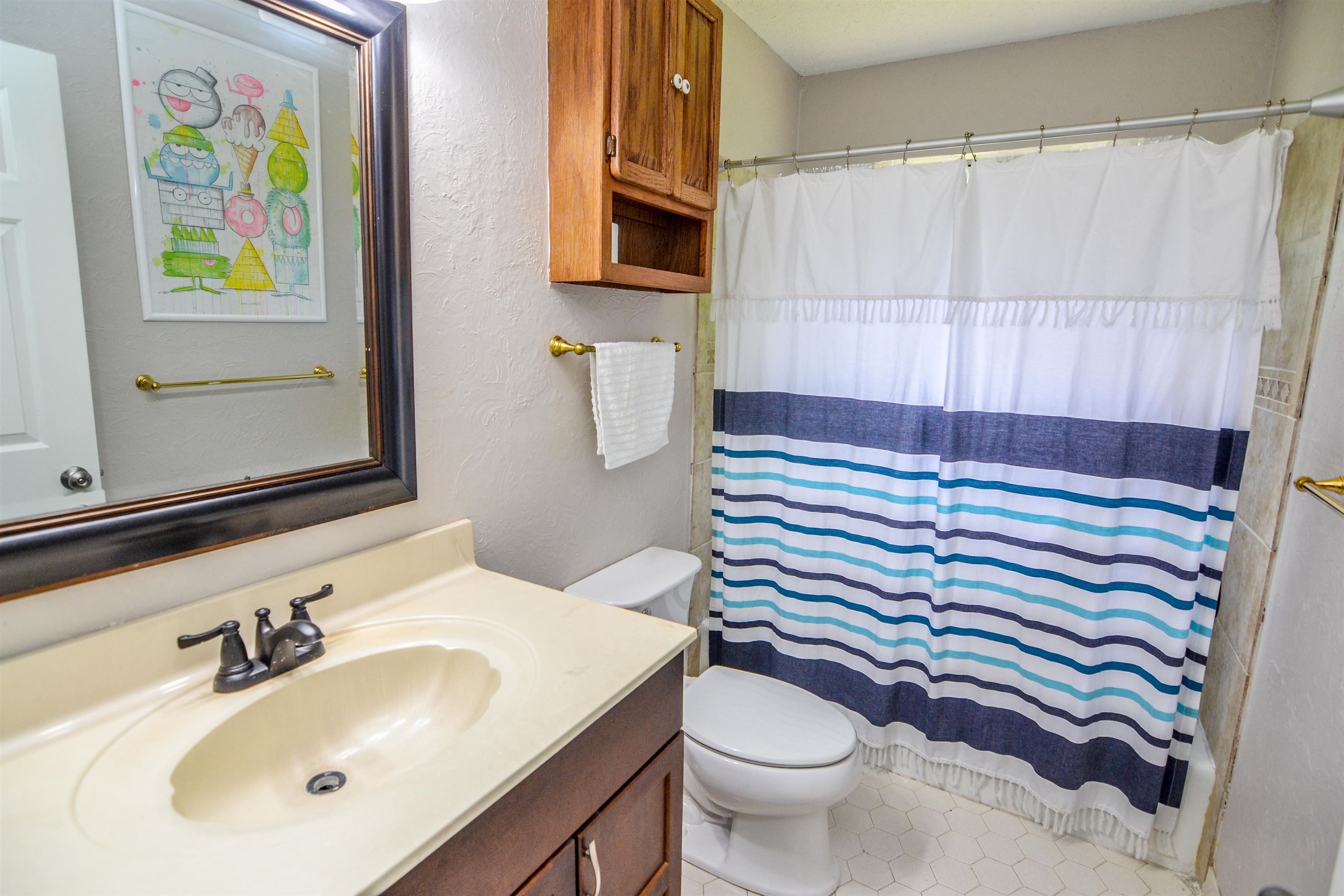 218 East Harpers Ferry Road Collierville, TN 38017 - Photo 18 of 25 a bathroom with a sink a toilet and a mirror