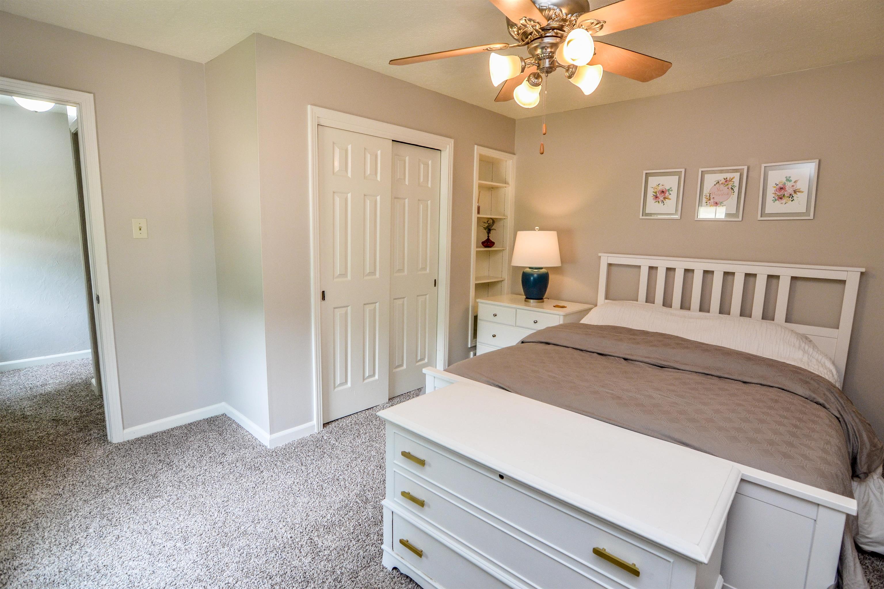 218 East Harpers Ferry Road Collierville, TN 38017 - Photo 20 of 25 a spacious bedroom with a bed and a chandelier