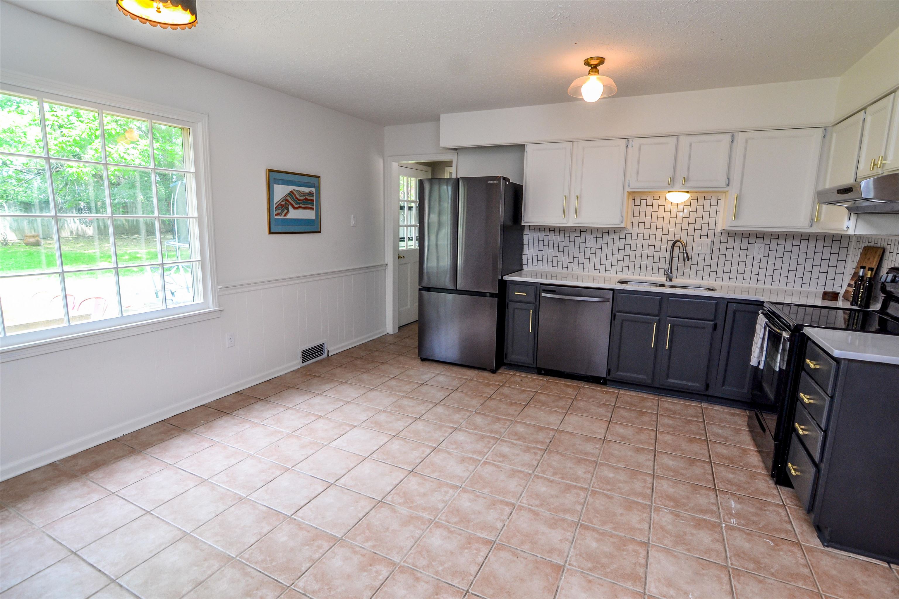 218 East Harpers Ferry Road Collierville, TN 38017 - Photo 9 of 25 a kitchen with stainless steel appliances granite countertop a sink refrigerator and microwave