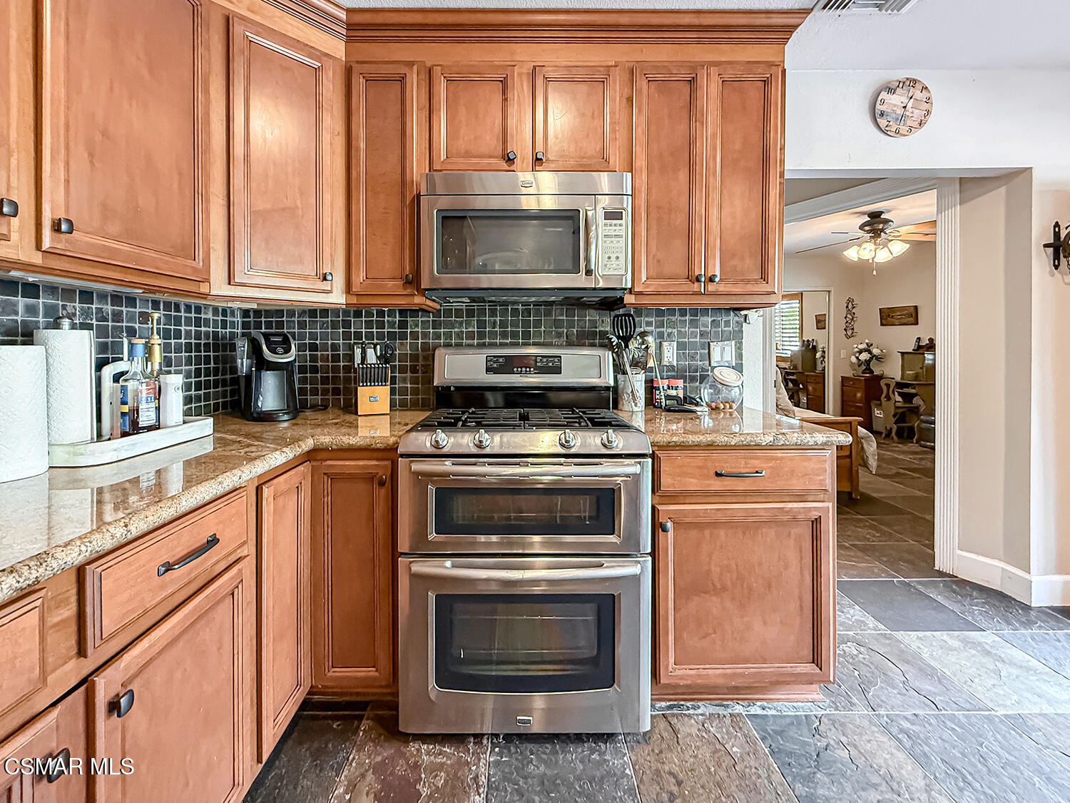 2189 Latham Street Simi Valley, CA 93065 - Photo 13 of 42 a kitchen with stainless steel appliances granite countertop a stove a sink and a microwave