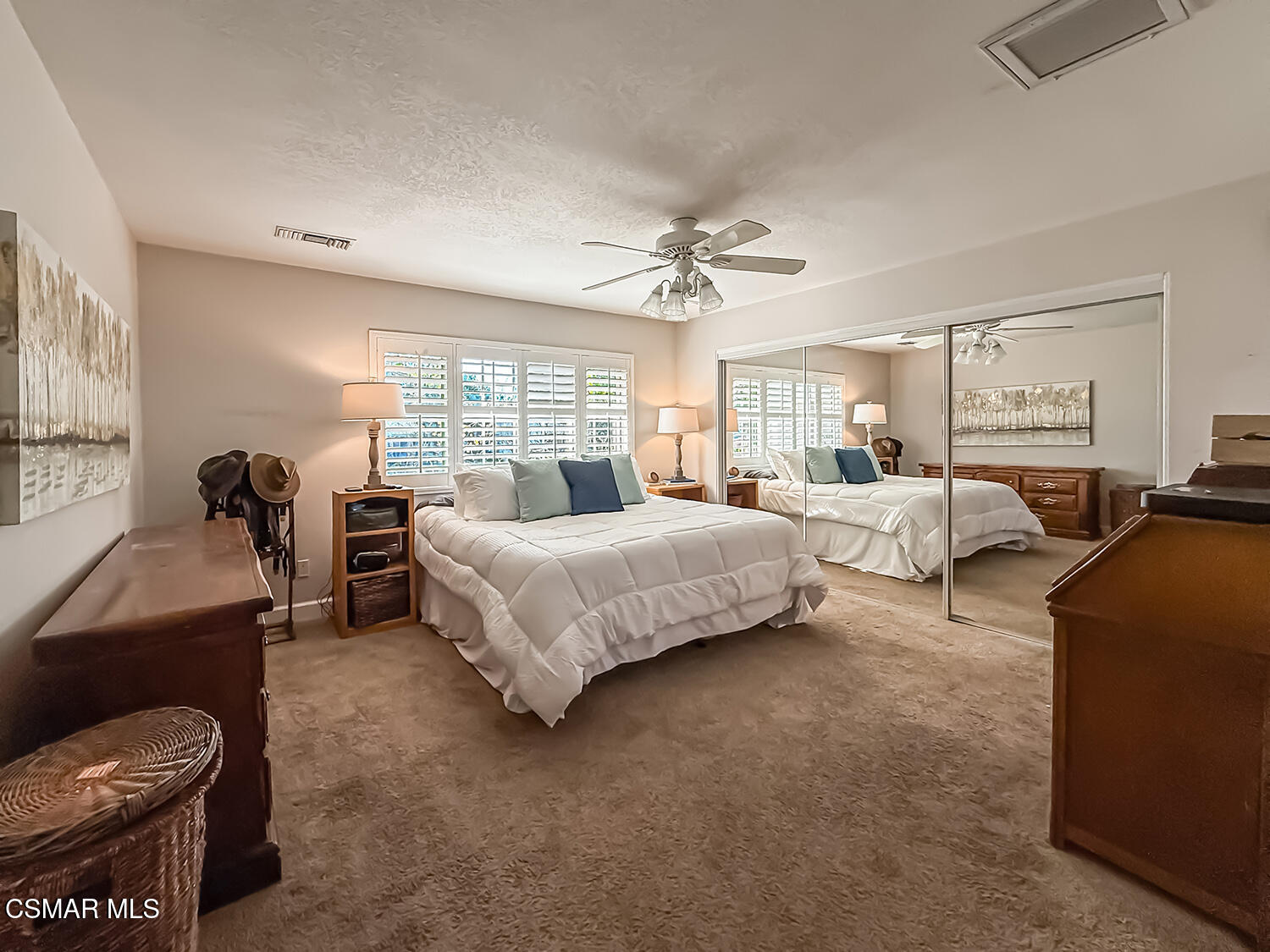 2189 Latham Street Simi Valley, CA 93065 - Photo 15 of 42 a spacious bedroom with a bed and a chandelier