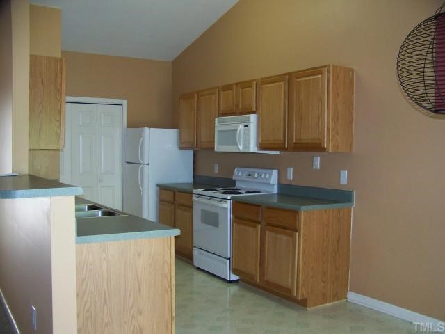 2517 Ferndown Court Raleigh, NC 27603 - Photo 5 of 10 a kitchen with stainless steel appliances granite countertop a refrigerator a stove and a sink