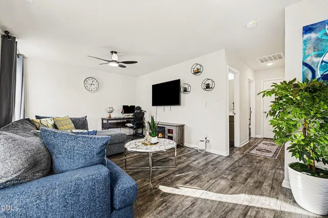a living room with furniture a rug and a window