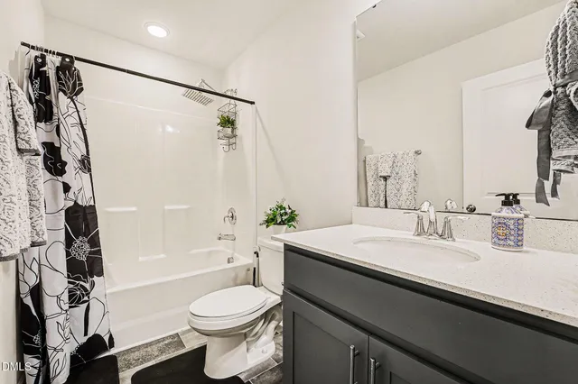 a bedroom with a bed and a ceiling fan