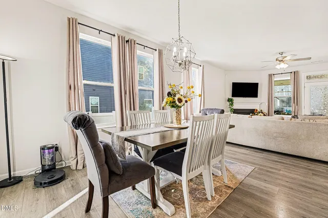 a view of a dining room with furniture and a chandelier
