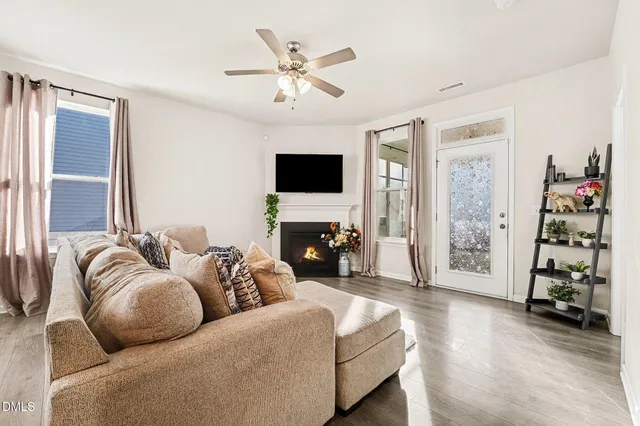 a living room with furniture a fireplace and a flat screen tv