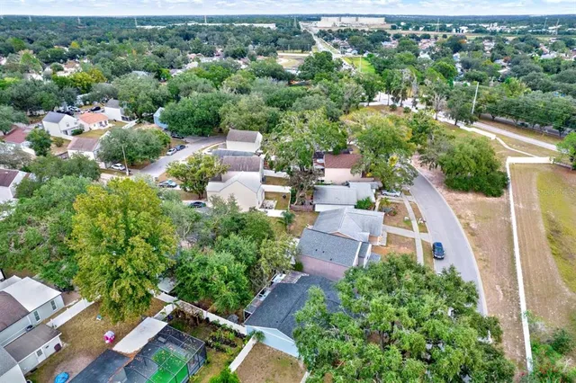 an aerial view of a house with a yard