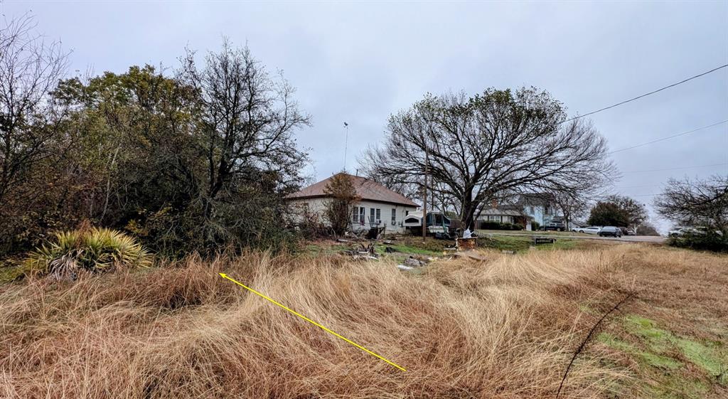 504 East Walnut Street Whitewright, TX 75491 - Photo 2 of 4 a view of a snow with a big yard