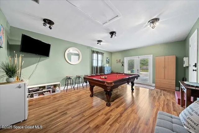 a living room with furniture a flat screen tv and a table