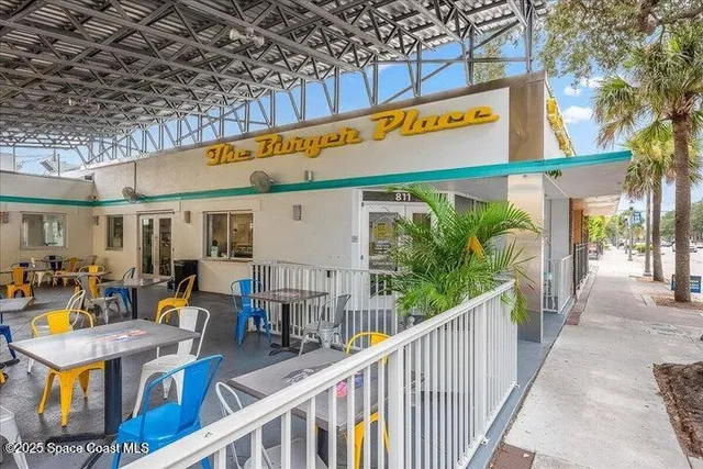 a view of a cafe with sitting area
