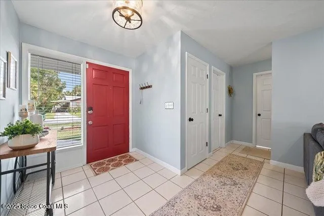 a view of an entryway with a table and chair
