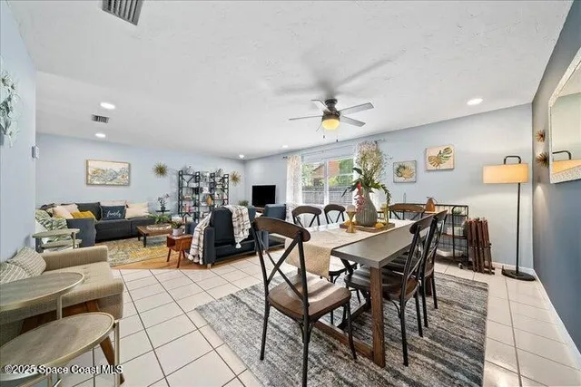 a living room with lots of furniture and painting on the wall