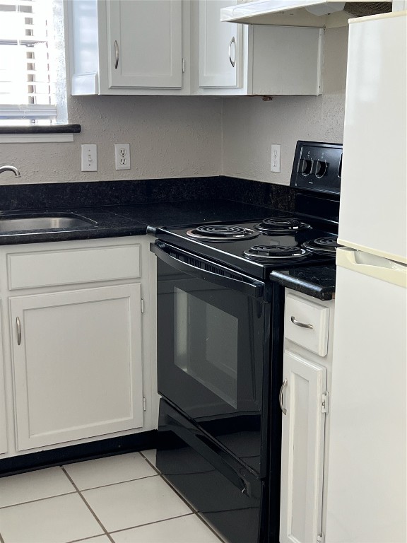 7575 Cambridge Street, Unit 1505 Houston, TX 77054 - Photo 3 of 7 a kitchen with white cabinets and black appliances