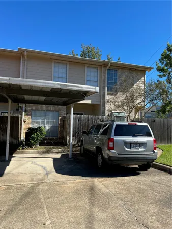 a front view of a house with car parked