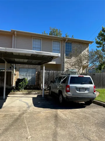 a front view of a house with car parked