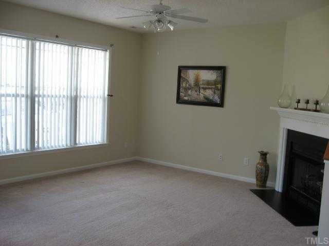 1104 Shackleton Road Apex, NC 27502 - Photo 3 of 12 View of living room revealing lots of space and windows.